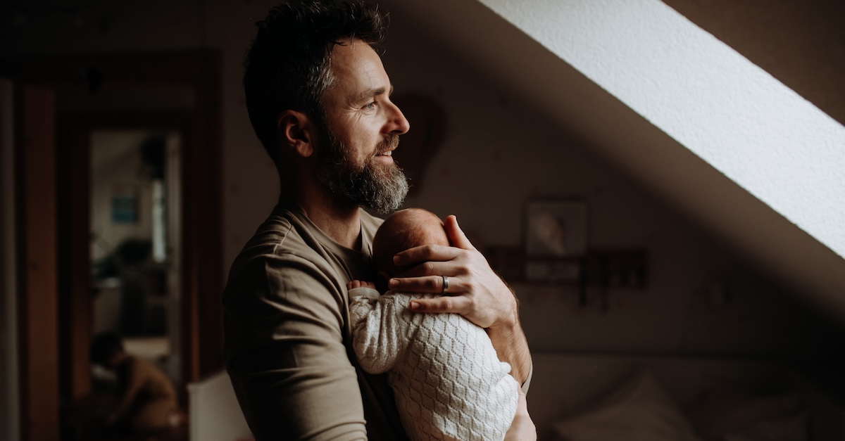 Father holding his newborn baby. Unconditional paternal love and Father's Day concept.
